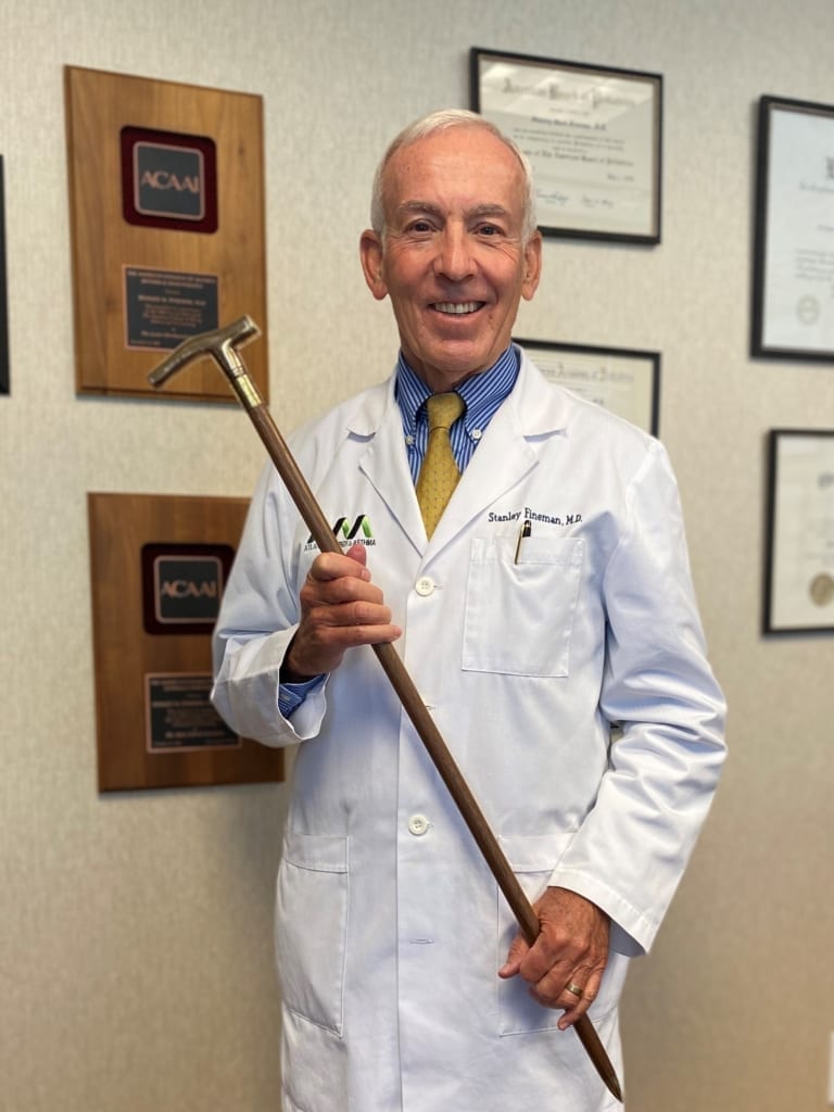 Stanley Fineman, MD, MBA, FACAAI showing off the Gold Headed Cane