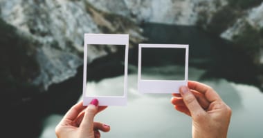 a woman comparing two different sizes of photo frames